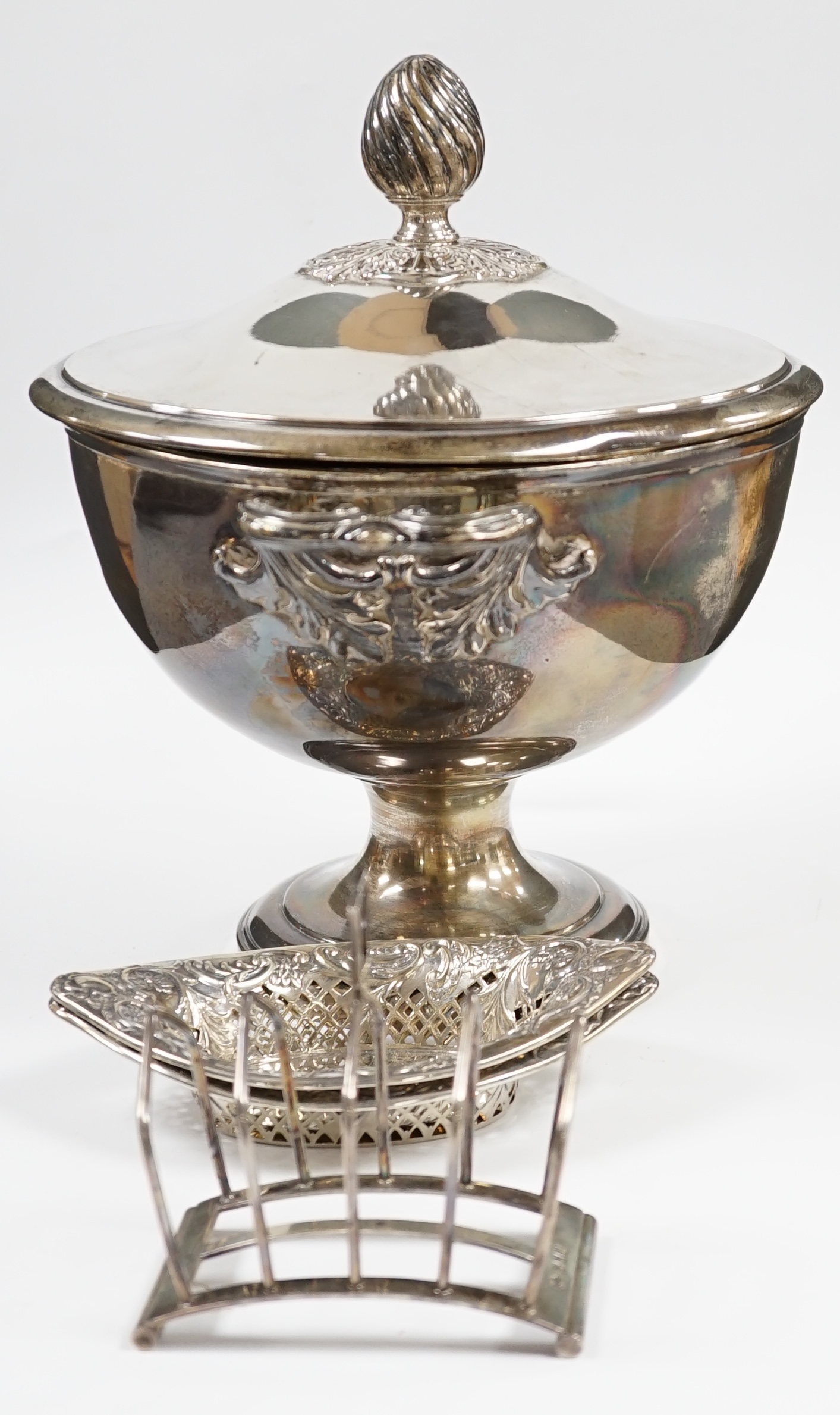 A pair of late Victorian pierced silver navette shaped bonbon dishes, 15.4cm, a silver five bar toast rack and a plated punch bowl and cover. Condition - poor to fair